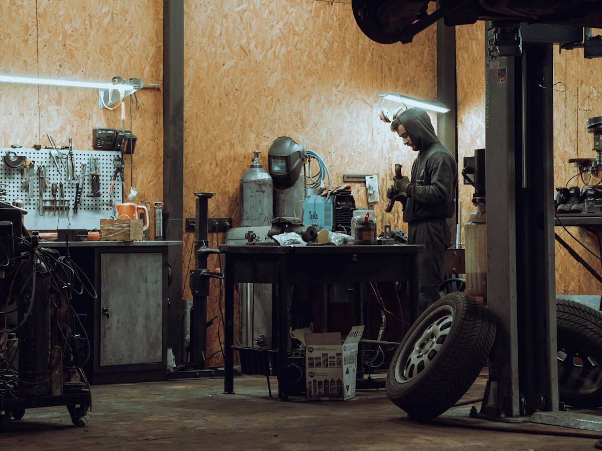 Workshop garage scene with technician at workbench